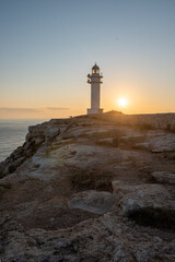 People walk down the street towards the Cap de Barbarie Lighthouse in Formentera in the summer of 2021.