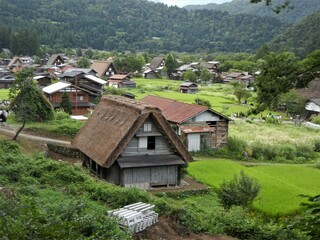 Fototapeta na wymiar Japanese traditional architecture日本の伝統的建築：合掌造りの家A house with a steep thatched rafter roof
