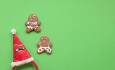 Gingerbread man cookies on green background. Copy space.