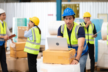 engineer or factory worker using laptop computer, talking with someone and surprise to something
