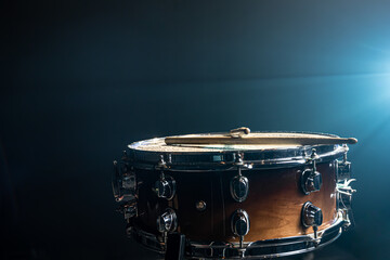 Fototapeta na wymiar Snare drum on a black background, musical instrument, musical concept.