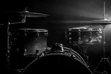 Fototapeta na wymiar Drum kit on a dark background with stage lighting, copy space.