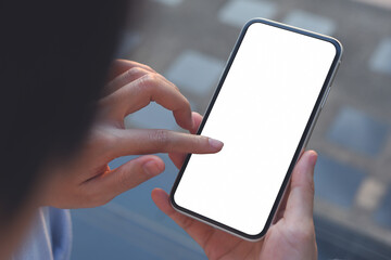 Mockup image of hand holding and finger touching on blank white screen mobile phopne