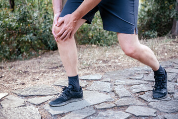 Man having knee pain while exercising due to runner's knee