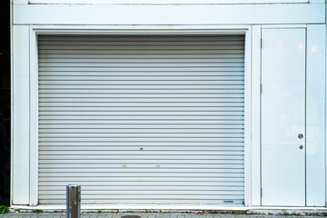 white shutter door of closed shop