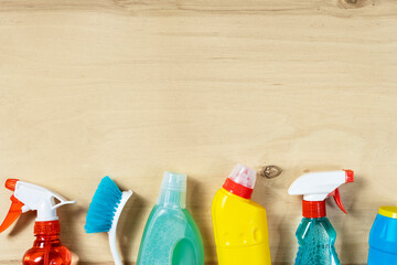 Cleaning concept. Set of cleaning supplies on wooden background with copy space, top view