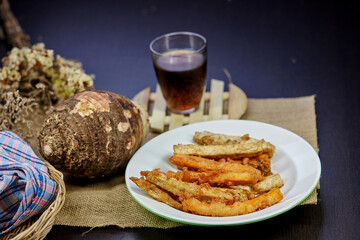 fried taro dessert on dish with glass of tea on the desk
