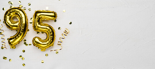 golden foil balloon number ninety five. Birthday or anniversary card with the inscription 95. gray...