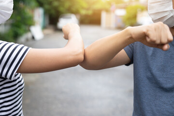Men and women touch each other with their arms as a sign of encouragement.