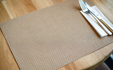 Top view of dining table with black kitchenware, silverware and cutlery..