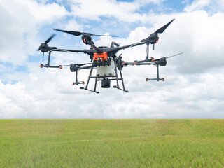 Agricultural drones make flights to prepare to spray rice fields. Agricultural technology smart farm concept.
