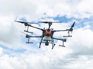 Fototapeta premium Agricultural drones make flights to prepare to spray rice fields. Agricultural technology smart farm concept.