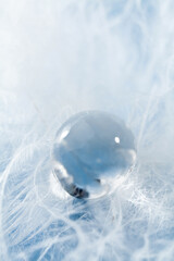 close up of a water drop on down feather.