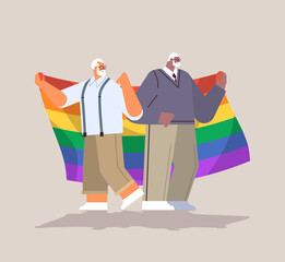 two senior men holding lgbt rainbow flag gay lesbian love parade pride festival transgender love concept
