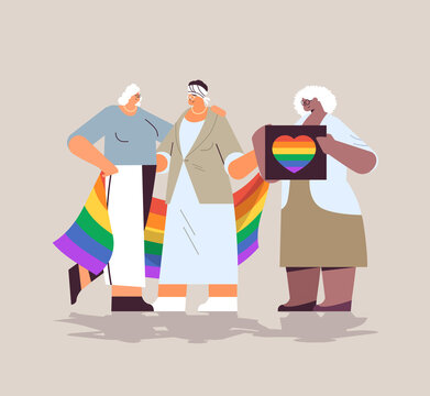 mix race senior women group holding lgbt rainbow flag lesbian love parade pride festival transgender love concept