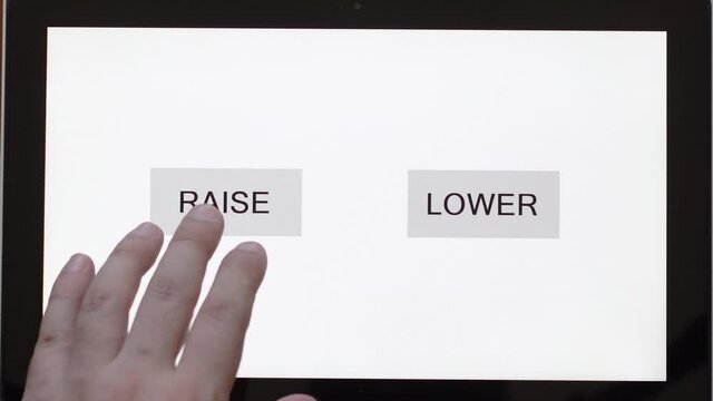 Close-up of a man's hand between the UP and DOWN buttons on a touchscreen. Business template with an empty space on the topic of stocks and tactics choice.