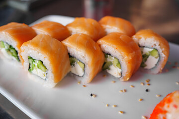 a set of Philadelphia rolls on a white plate. Japanese cuisine. 