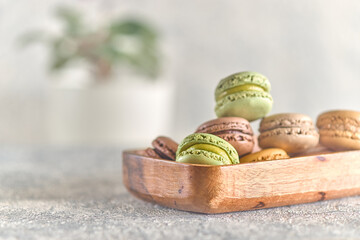 Macarons stacked in a wooden plate