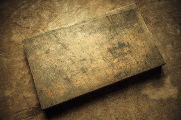 An old rectangular wooden box on a wooden table in the office. Vintage style.