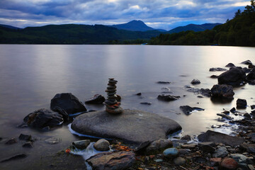 A Small pile of Stones beside a Tranquil Loch Ard, Trossachs, Scotland, UK.