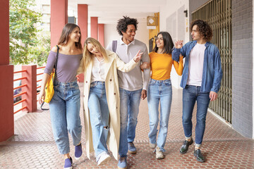 Multi-ethnic group of friends walking together on the street.