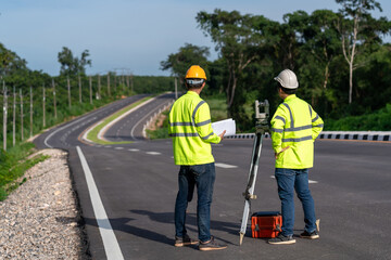 Asian surveyor engineers worker making measuring with theodolite instrument equipment during...