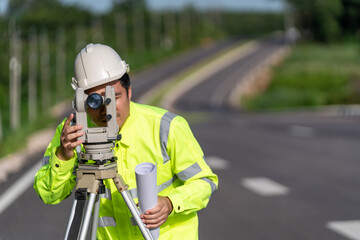 Close up of Asian surveyor engineer worker making measuring with theodolite on road works. survey...