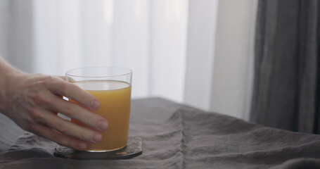 man take orange juice in tumbler glass