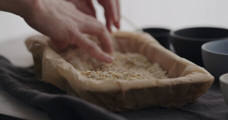 Obraz na płótnie Canvas man making granola at home, mix flakes