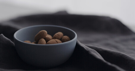 chocolate covered cocoa beans in blue bowl