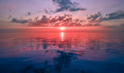 Naklejka na ściany i meble Photo of a sunset on the sea. Evening landscape, moroe, waves, sunset.