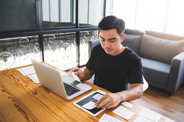 Web designer working laptop tablet user interface design creative UI Ux designer planning designing text image layout application development for smartphone intuitive interactive navigation technology