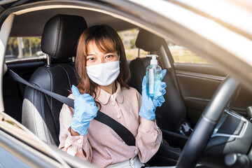 Asian woman beautiful attractive driving car vehicle traveling using hand sanitizer gel wearing protective facemask gloves protection infection safety during coronavirus covid-19 outdoor pandemic