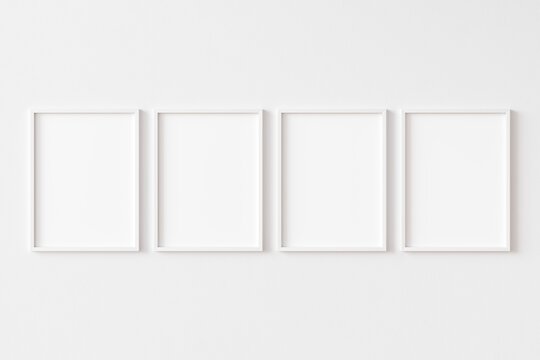 Group of four rectangular picture frames with white border hanging on white wall. Empty template for adding your content. 3D illustration.