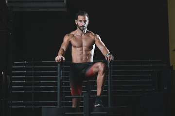 a 40-year-old man doing physical exercise in a gym.