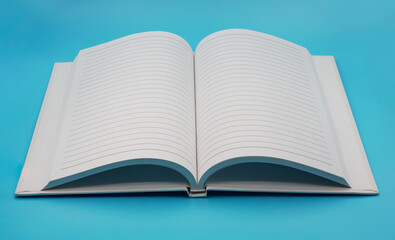 opened blank white notebook isolated on light blue background