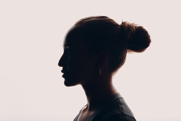 Adult young woman dark silhouette portrait in studio