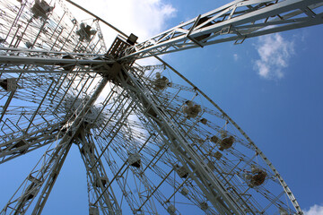 Ferris wheel on blue sky background. 