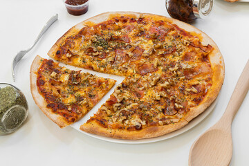 Small Pizza with Tomato, Fried Smoked Bacon and Chopped Walnuts with Tomato and Mozzarella Cheese on White Plate