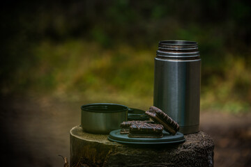 thermos with cookies in the forest