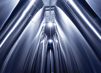 Rows of steel tanks for beer fermentation and maturation in a craft brewery