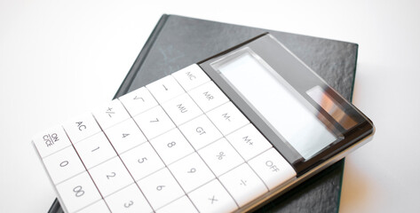 calculater ,pen and blank notebook for office on white background isolated