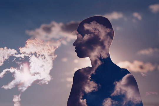 Psychology and european woman mental health contemplation concept. Multiple exposure clouds and sun on female head silhouette.