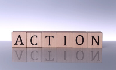 ACTION word made with building blocks isolated on grey background