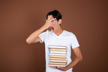 Rest and study at the university. Handsome guy with books.