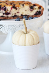 A simple decoration for the table with white baby boo pumpkin.
