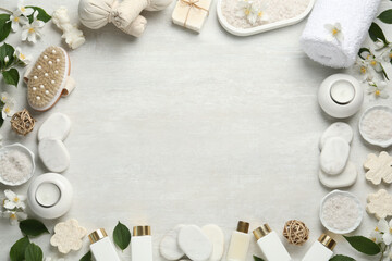Jasmine flowers and set of spa essentials on white wooden table, flat lay. Space for text