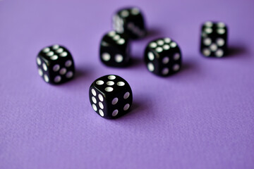 Dice are black and white on a purple background