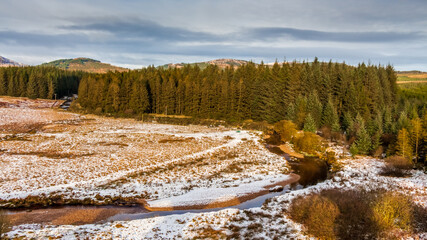 Sun shining over a snow covered Big Water of Fleet at Cairnsmore in winter