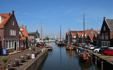 Fototapeta premium Beautiful Dutch city on water. Classic Dutch architecture. Sunny day city view. Authentic houses of the Netherlands. 